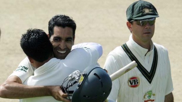 Umar Gul is embraced after hitting the winning run against Australia.