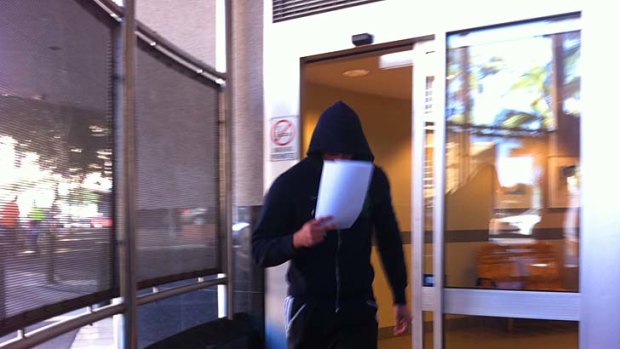 A member of the Bandidos outlaw bikies gang leaves the Brisbane watchhouse after being charged over an attack at a restaurant last month.