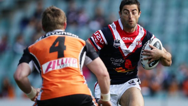 On the attack ...   Anthony Minichiello runs at Chris Lawrence.