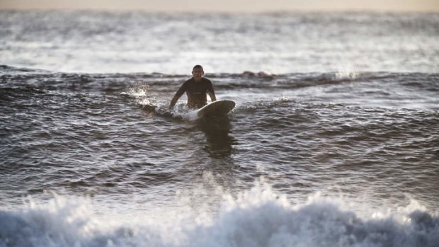 Just another anonymous surfer: Prime Minister Tony Abbott riding the waves.