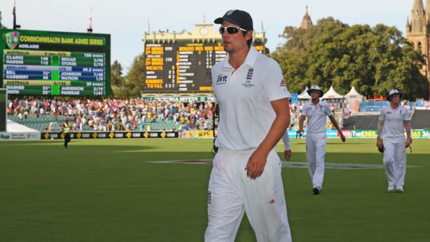 Rallying call: England captain Alastair Cook cut a lonely figure as he left the pitch in Adelaide.
