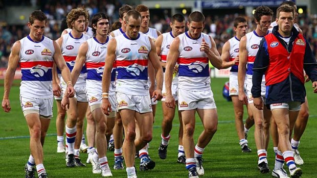 Dog of a day: The Bulldogs, tails between their legs, traipse off after their flogging by the Eagles.