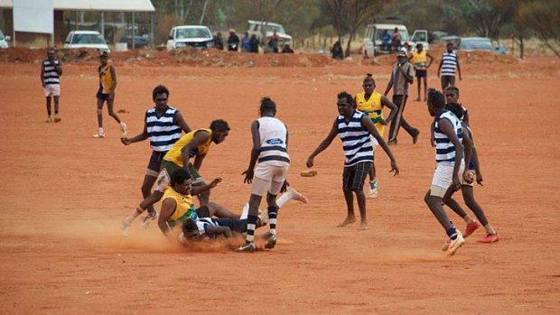 Pure delight: Players compete at a football carnival at the Mutitjulu ground near Uluru.