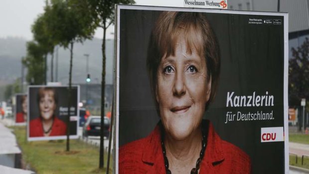 Campaign trail: Posters of Angela Merkel line up in front of the Dusseldorf ISS Dome before the rally.