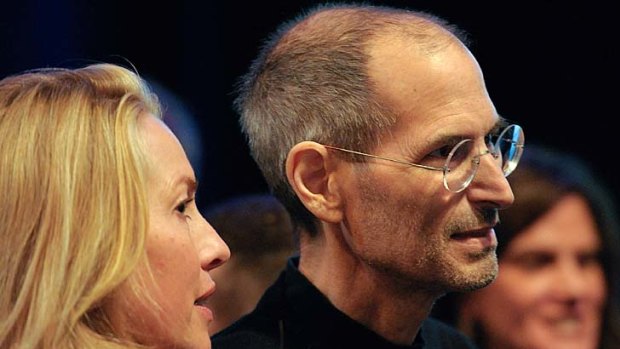 Steve Jobs greets members of the public with his wife Laurene Powell Jobs in June.