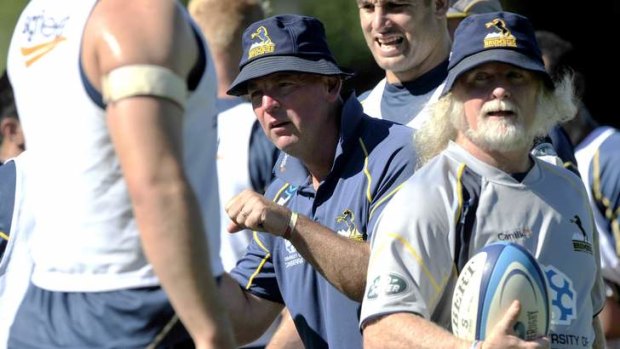 Brumbies Coach Jake White, centre, and Laurie Fisher, right, during training.