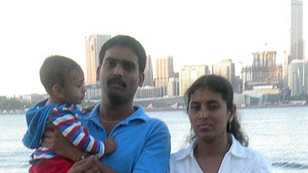 Drowned man Praveen Kumar Shiva holding his young son, with his wife Madhavi.