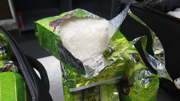 Authorities have charged two Malaysian nationals over an unprecedented ice and heroin discovery at Melbourne Airport.