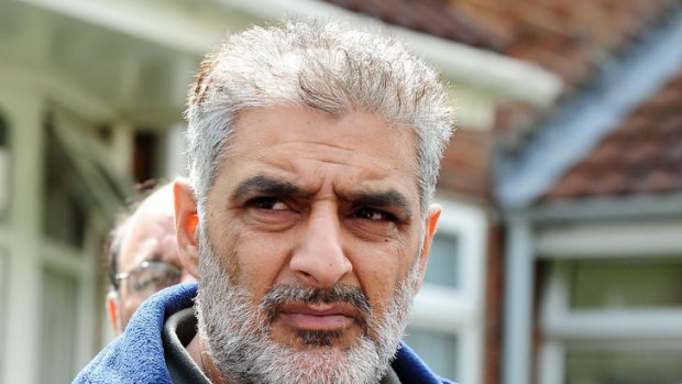 Grief ... Tariq Jahan holds a picture of his son Haroon Jahan.