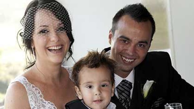 Darren Smith with his wife Angela on their wedding day with son Mason.