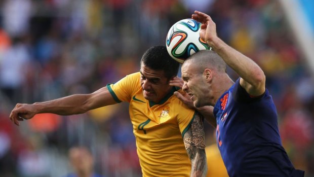 Pushed Netherlands to the edge ... Tim Cahill of Australia goes up for the ball with Ron Vlaar of the Netherlands.