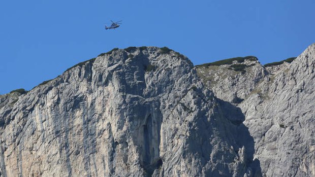 A helicopter flies above the Berchtesgaden Alps, near the Austrian border.