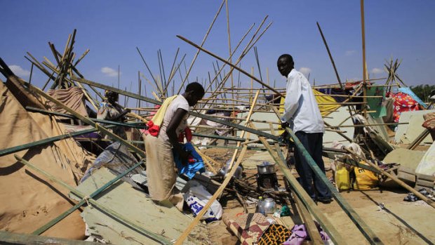 A displaced family from South Sudan's Nuer tribe, who fled their home in fear of ethnic killing by the Dinka-led government, erects a makeshift shelter inside the United Nations Mission in Sudan facility in Jabel, on the outskirts of Juba.