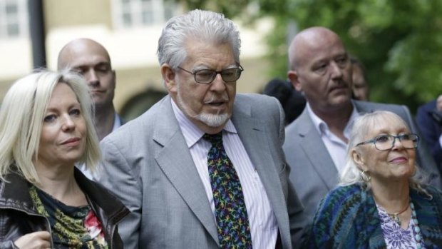 Rolf Harris arrives with daughter Bindi, left, and wife Alwen Hughes at Southwark Crown Court in London on Tuesday.