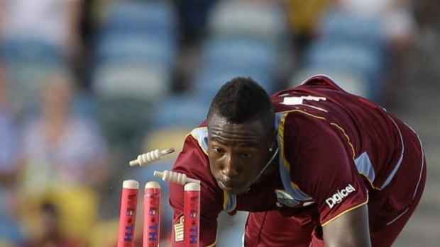 West Indies' Andre Russell runs out England's James Tredwell.