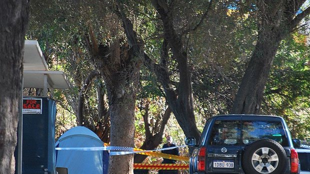 Police officers investigate the scene of the gas bottle blast, which ripped apart the Spies' tent at a Mandurah caravan park.