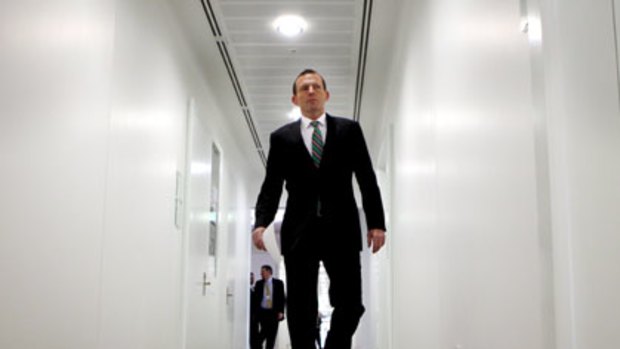Tony Abbott strides the corridors of parliament.