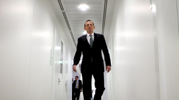 Tony Abbott strides the corridors of parliament yesterday.