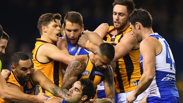 Players wrestle after a bump by Kangaroo Jack Ziebell on Sam Mitchell.
