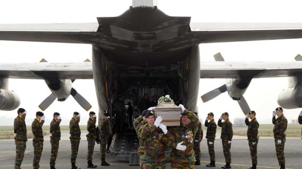 Sad and solemn ... soldiers carry a child's white coffin.