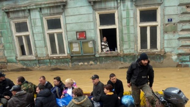 A group is evacuated over flooded streets in the Serbian town of Obrenovac.