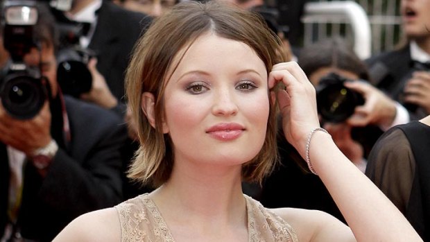 Emily Browning on the red carpet at Cannes. Her tattoo reads 'a blessed unrest that keeps us marching'.