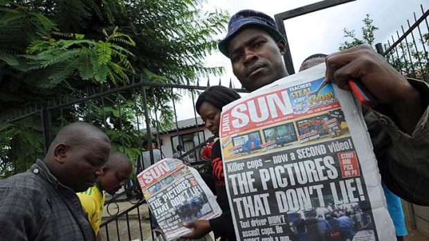 Outraged ... relatives of Mido Macia with the Daily Sun's evidence.