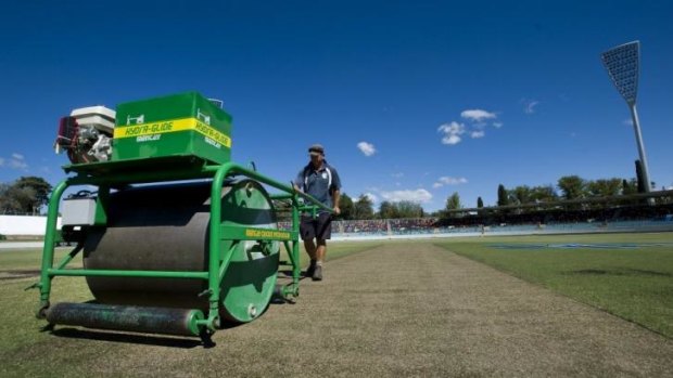 On a roll: Manuka Oval curator puts the roller over the pitch on Tuesday.
