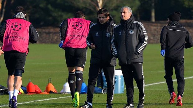 Growing vexed: Jose Mourinho, second right, attends a training session at Chelsea's training ground.