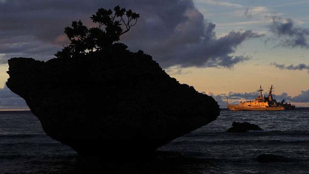 "Unfortunate" ... a Navy ship is anchored just offshore at Flying Fish Cove on Christmas Island.