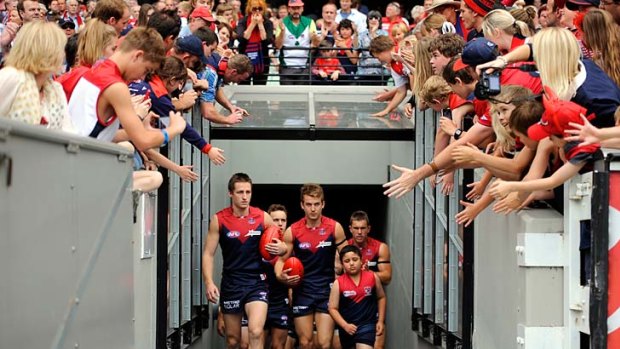 Melbourne make their entrance to the MCG for the first time in 2012.