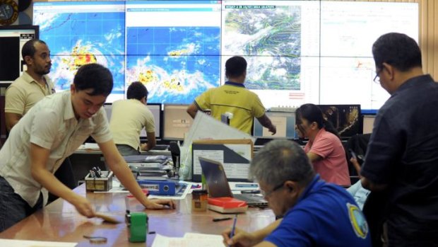 Meteorologists monitor the movement of typhoon Rammasun at the Philippine Atmospheric, Geophysical and Astronomical Services Administration in Manila.