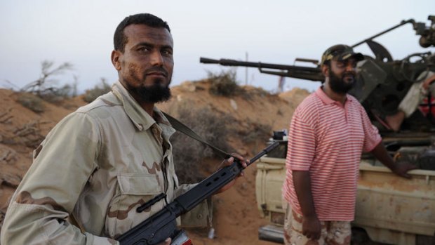 NTC fighters from the Zintan Martyr Brigade rest near the front line close to Umm Khanfis, some 80 km east of Sirte.