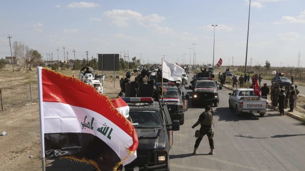 Iraqi security forces prepare to attack Islamic State extremist positions in Tikrit on Thursday.