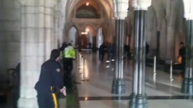 Police officers respond to shooting attacks inside the Centre Block of the parliament buildings in Ottawa.