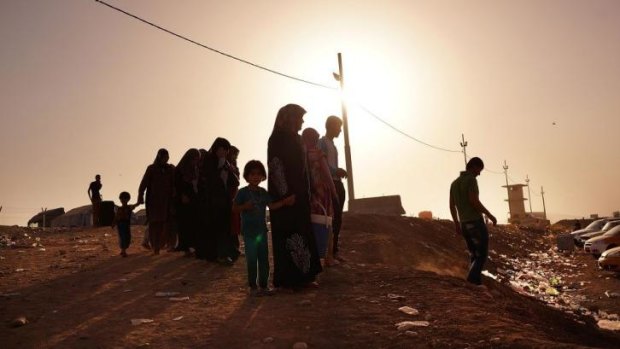 Families outside a displacement camp in Khazair, Iraq. The camp is now home to an estimated 1500 people.