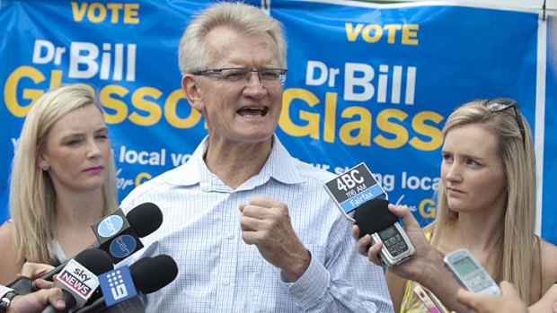 LNP candidate Bill Glasson speaks to the media with his daughters Gemma (left) and Nicola (right) at Coorparoo State school.