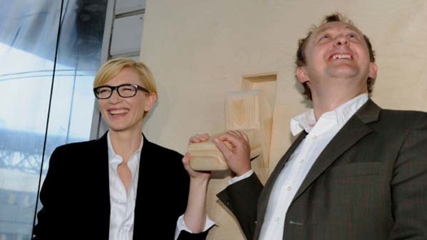 Sydney Theatre Company  artistic directors Cate Blanchett  and Andrew Upton  use a wooden switch to make a symbolic "switch on" of a massive solar array on the roof of STC's home base in Sydney.
