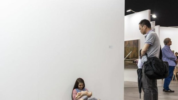Patricia Piccinini takes a break at Art Basel at the Hong Kong Convention and Exhibition Centre in Hong Kong.