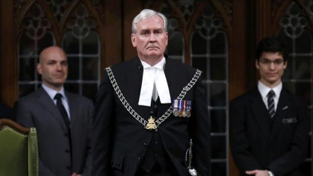 Hailed as a hero ... Canada's Sergeant-at-Arms Kevin Vickers is applauded in the House of Commons in Ottawa. Vickers confronted and shot Michael Zehaf-Bibeau in Canada's Parliament.