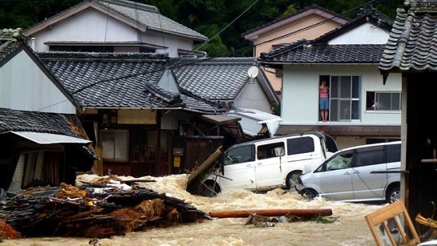Overflowing water from a river floods a residential area in Nachikatsuura, central Japan.