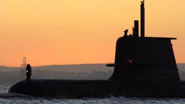 The submarine HMAS Collins surfaces at sunrise.