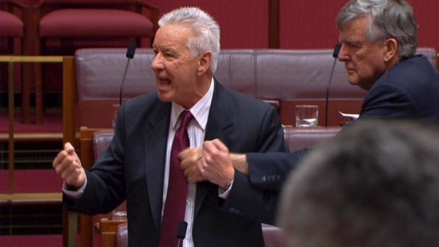 Liberal senator Bill Heffernan gives Labor senator Doug Cameron a tap.