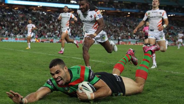 Tongue lashing: Greg Inglis scores one of his four tries against a dismal Tigers outfit.