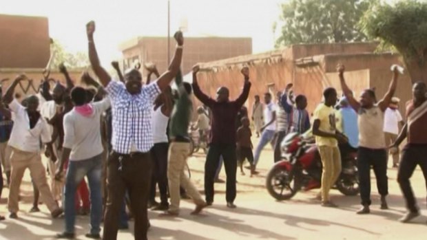 Protesters chant and raise their arms in Niamey, Niger, following the publication of Charlie Hebdo.