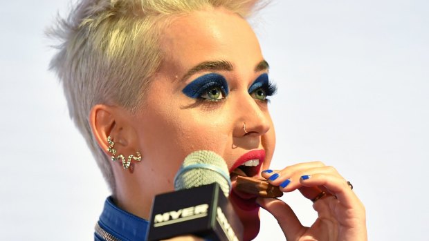 Katy Perry enjoys a Tim Tam during her promo visit to Australia.