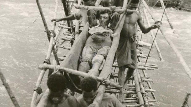 A wounded Australian soldier being carried by local men in Papua New Guinea during World War II.