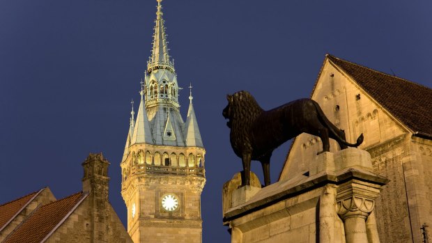 A 12th-century bronze lion at Braunschweig castle square, with the town hall in the background.  