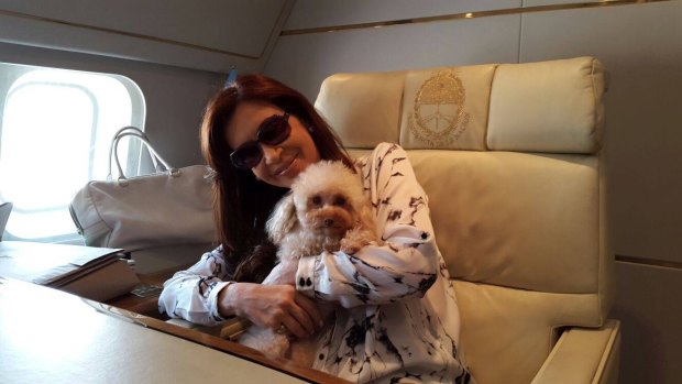 Argentine President Cristina Fernandez with her dog Lolita, on board the presidential plane Tango 01.