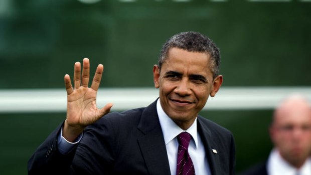 US President Barack Obama waves as he arrives at the White House in Washington.